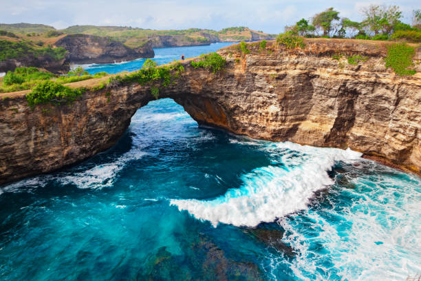 Walk across the awe-inspiring natural bridge at Broken Beach.