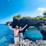 Massive natural rock archway over the turquoise ocean at Broken Beach, managed by Nusa Penida Transport Group
