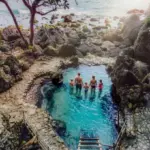 Crystal clear natural freshwater pool inside Tembeling Forest next to the sea in South Nusa Penida