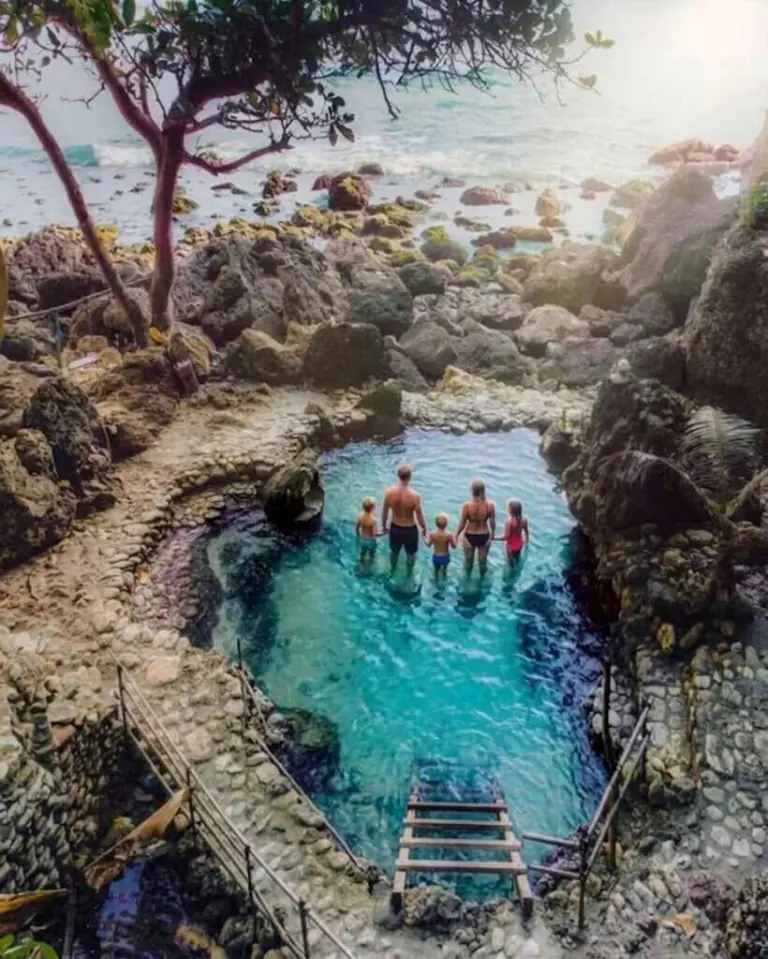 Crystal clear natural freshwater pool inside Tembeling Forest next to the sea in South Nusa Penida